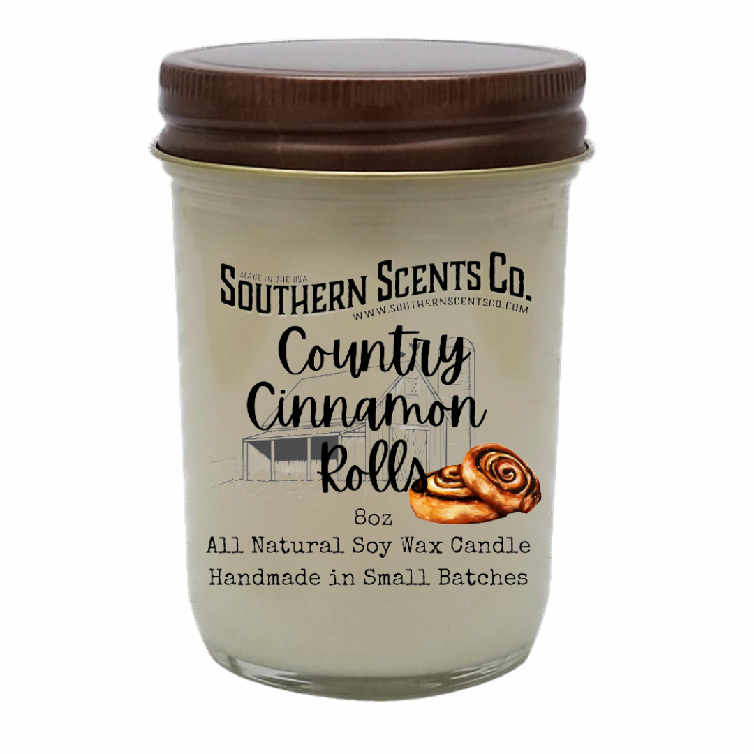 Glass candle jar with brown lid labeled 'Southern Scents Co. Country Cinnamon Rolls' on a white background